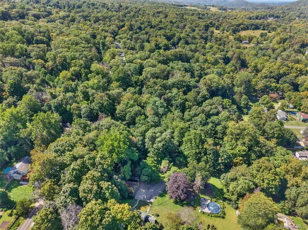 a backyard of a house with lots of green space and trees
