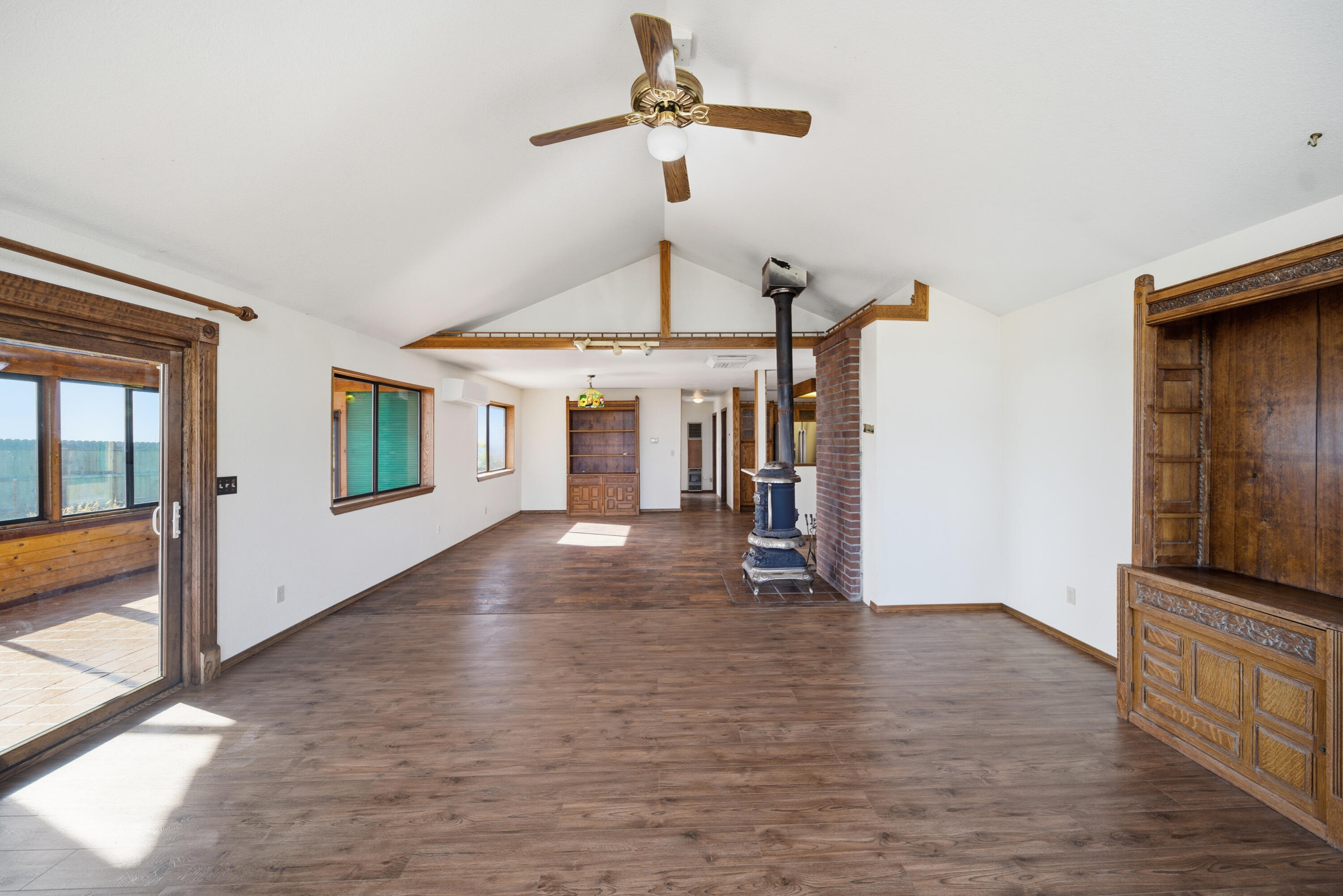 14018 Highview Trail Redding, CA 96003 - Photo 17 of 41 a view of a livingroom with wooden floor a ceiling fan and windows
