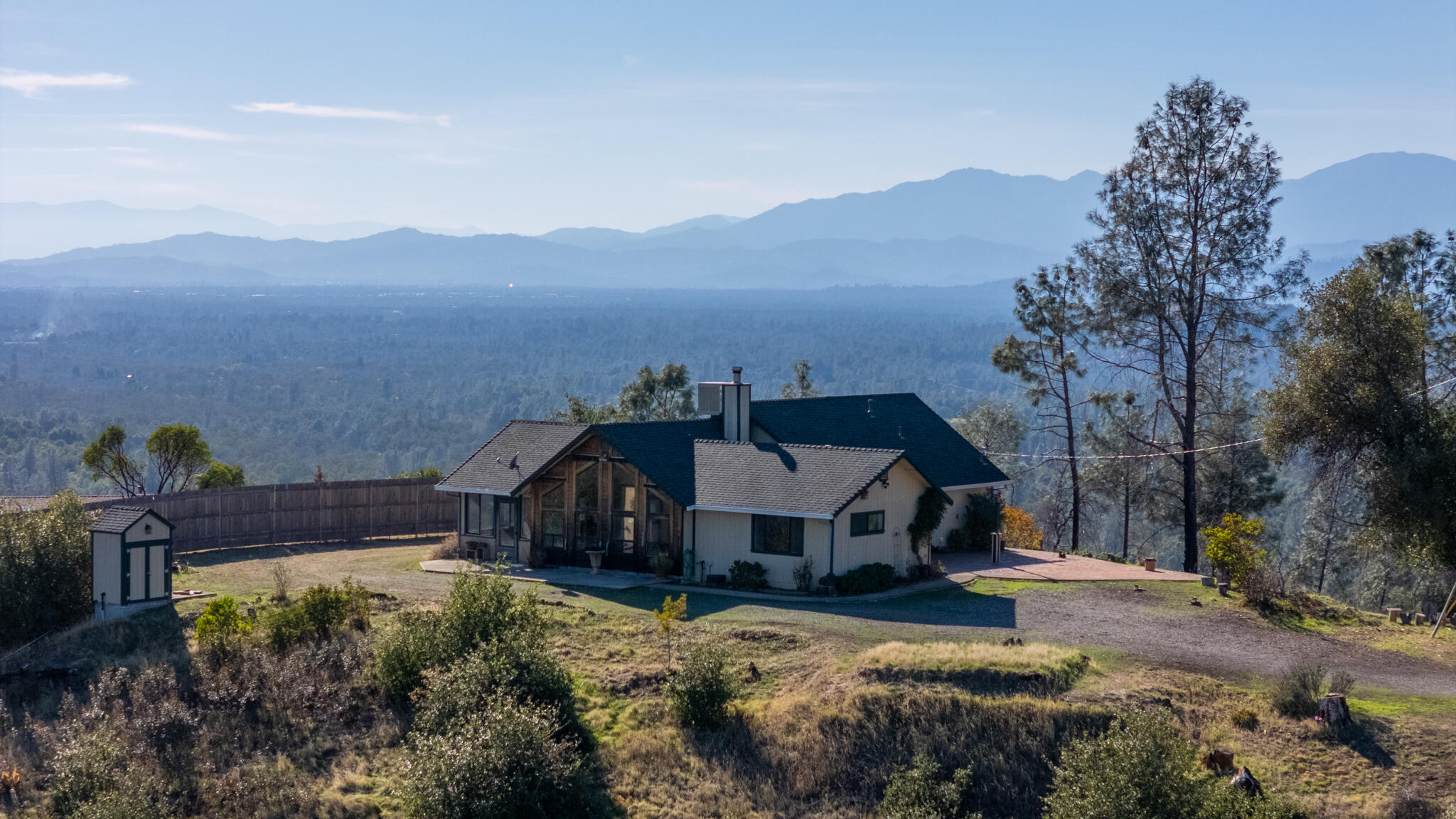 14018 Highview Trail Redding, CA 96003 - Photo 6 of 41 a view of a house with wooden fence and a mountain in the background