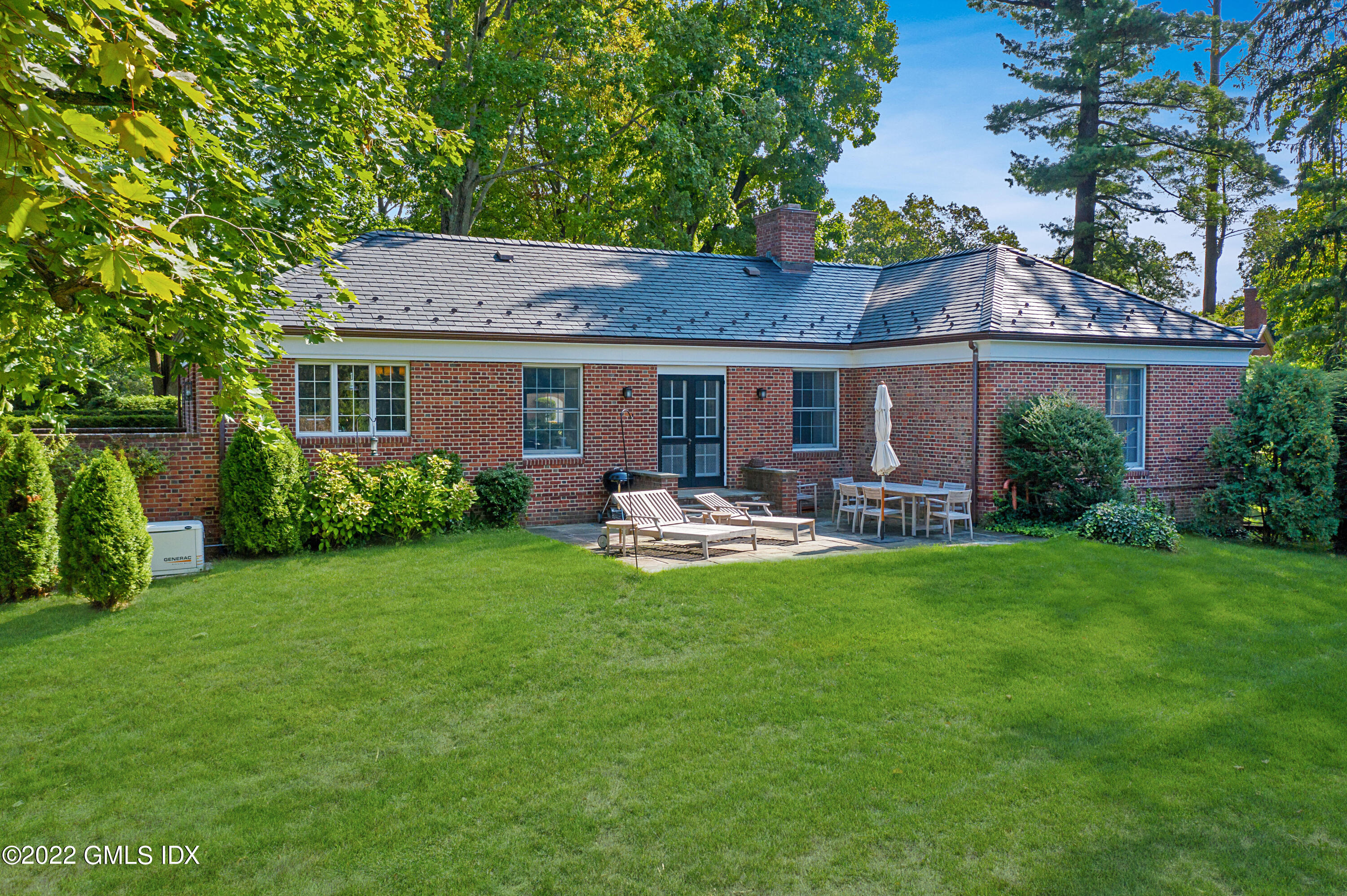30 Field Point Drive, Unit GUEST HOUSE Greenwich, CT 06830 - Photo 2 of 11 a front view of a house with garden