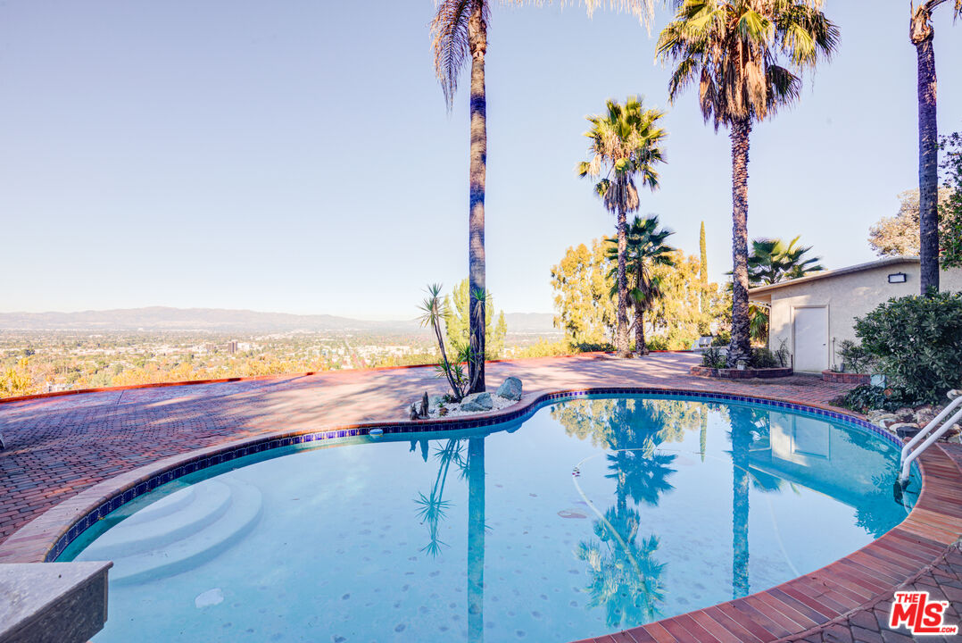 4520 Gable Drive Encino, CA 91316 - Photo 11 of 58 a view of a swimming pool with a yard and plants
