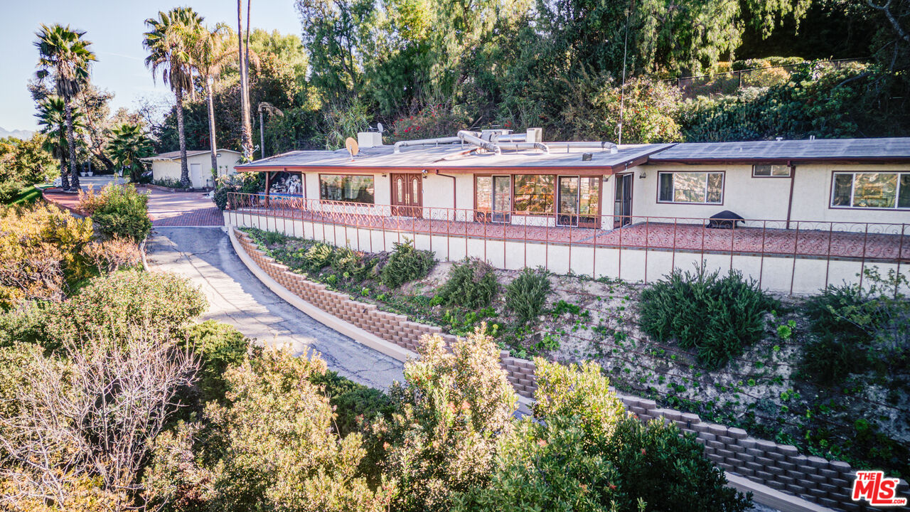 4520 Gable Drive Encino, CA 91316 - Photo 2 of 58 a front view of a house with a yard and potted plants