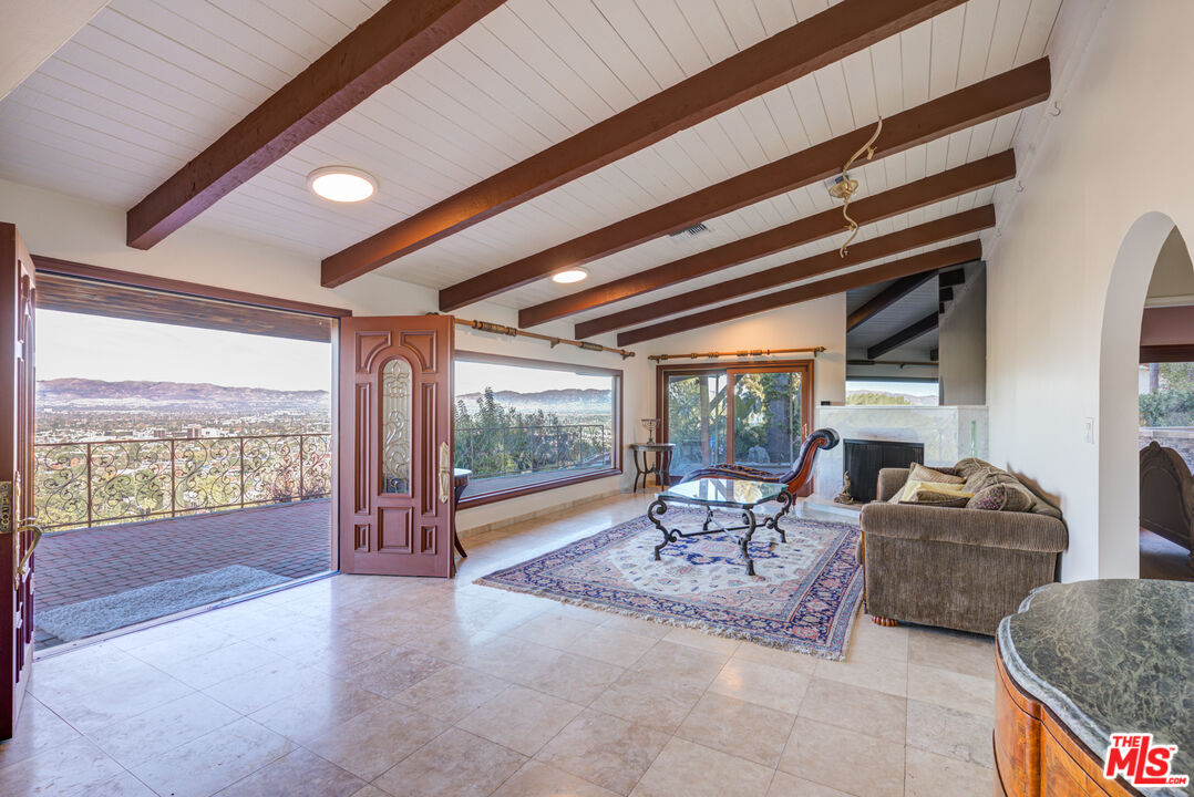4520 Gable Drive Encino, CA 91316 - Photo 28 of 58 a living room with furniture and a floor to ceiling window