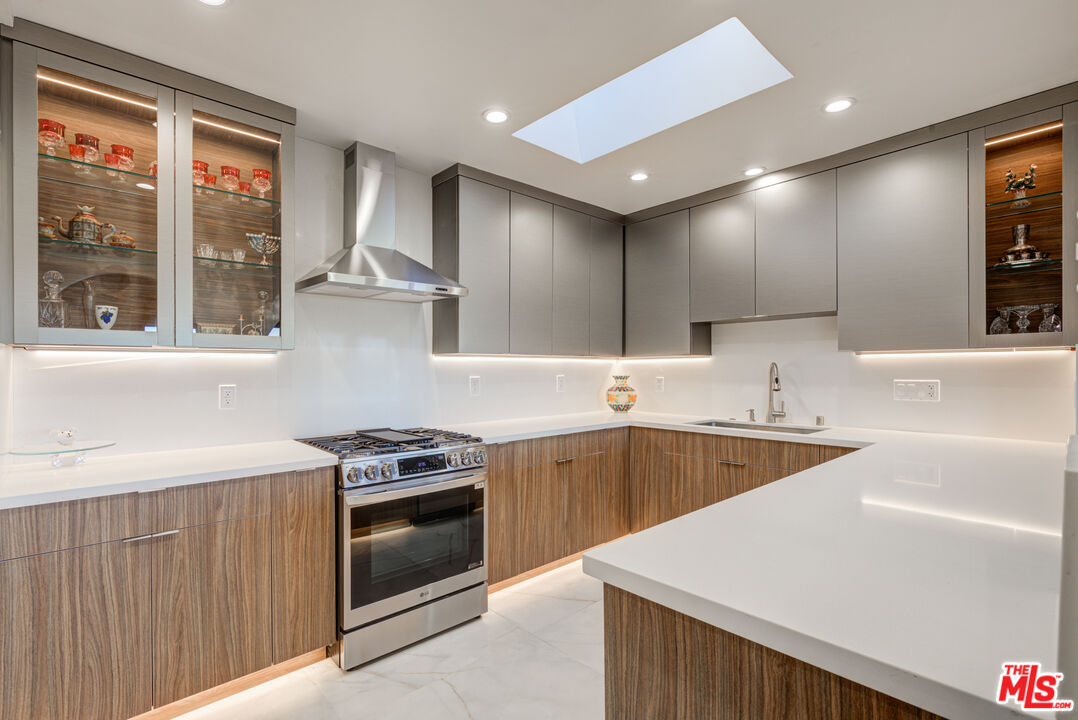 4520 Gable Drive Encino, CA 91316 - Photo 40 of 58 a kitchen that has a sink a stove and cabinets