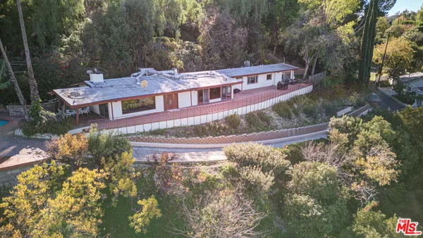 a front view of a house with a yard and a fountain