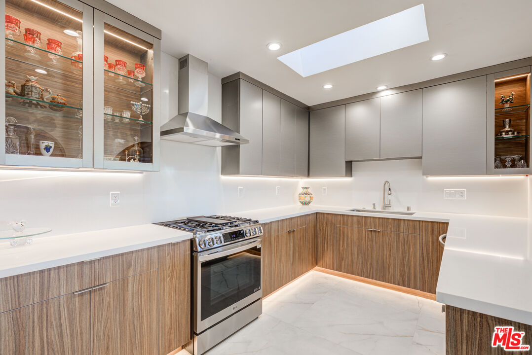 4520 Gable Drive Encino, CA 91316 - Photo 42 of 58 a kitchen with stainless steel appliances granite countertop a sink stove and refrigerator