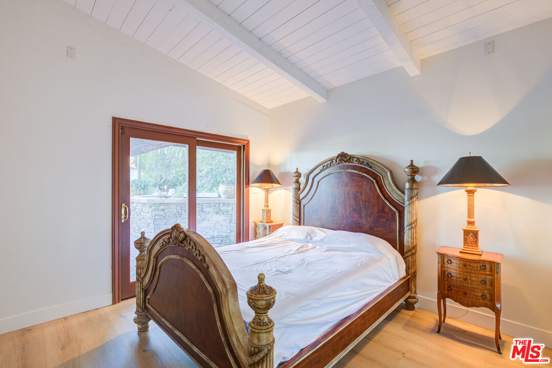 4520 Gable Drive Encino, CA 91316 - Photo 47 of 58 a bedroom with a bed and wooden floor