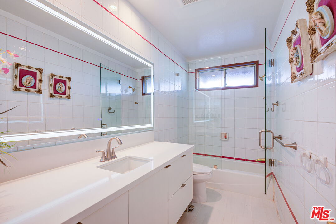 4520 Gable Drive Encino, CA 91316 - Photo 57 of 58 a bathroom with a sink a mirror and a shower