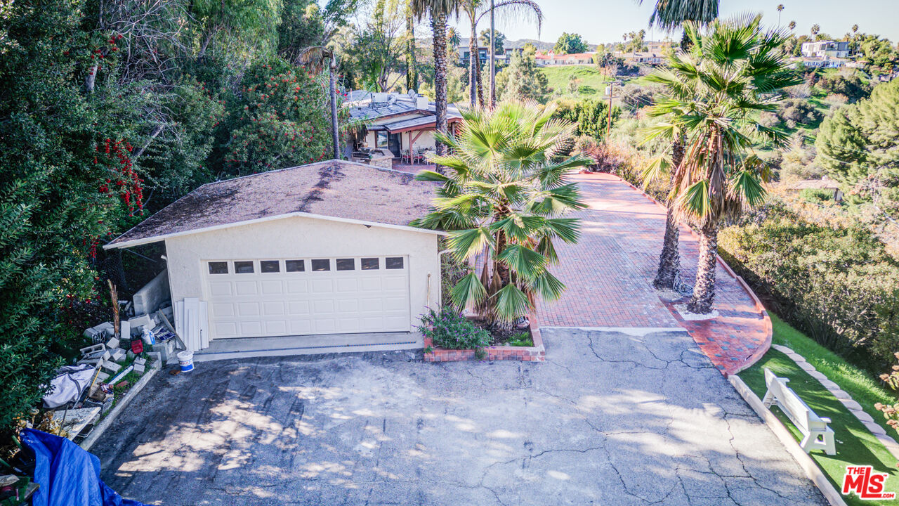 4520 Gable Drive Encino, CA 91316 - Photo 7 of 58 a front view of a house with a yard and a fountain