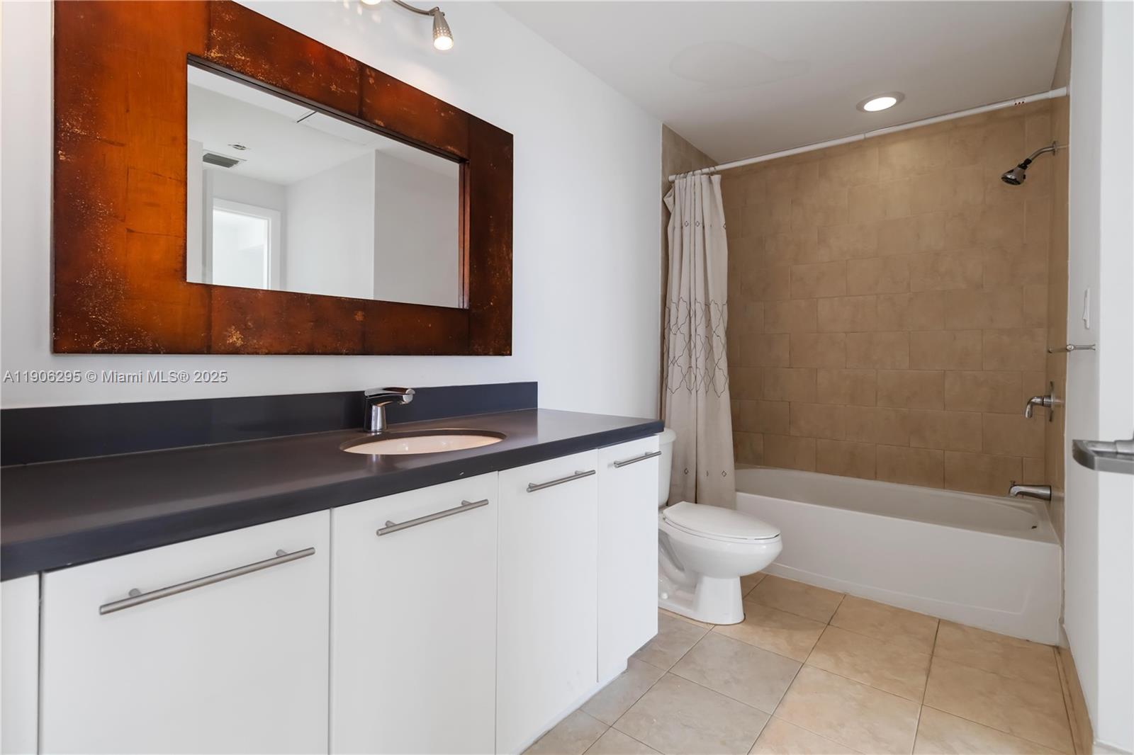 90 Southwest 3rd Street, Unit 4305 Miami, FL 33130 - Photo 9 of 16 a bathroom with a granite countertop sink a toilet and a mirror