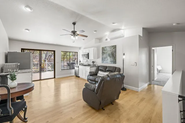 a living room with furniture and a chandelier