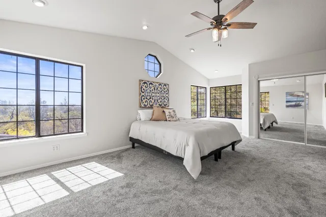 a spacious bedroom with a large bed and a window