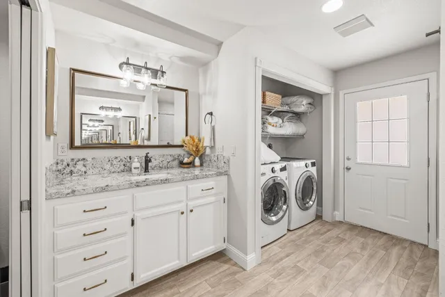 a bathroom with a sink a washer and dryer