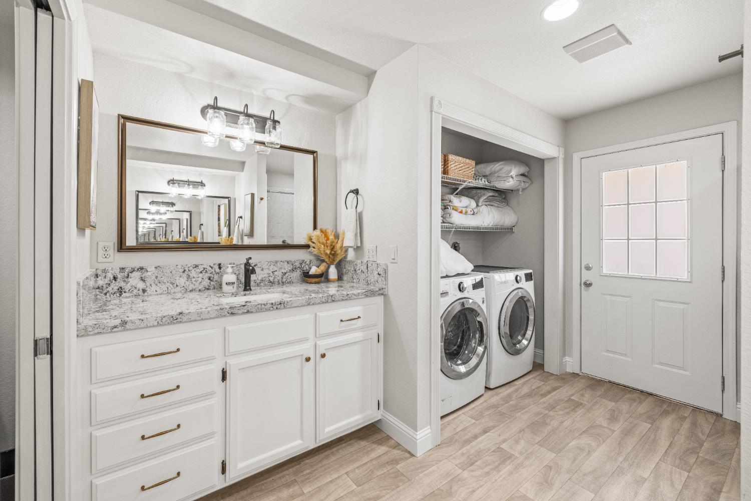 14580 McElroy Road Auburn, CA 95602 - Photo 18 of 48 a bathroom with a sink a washer and dryer