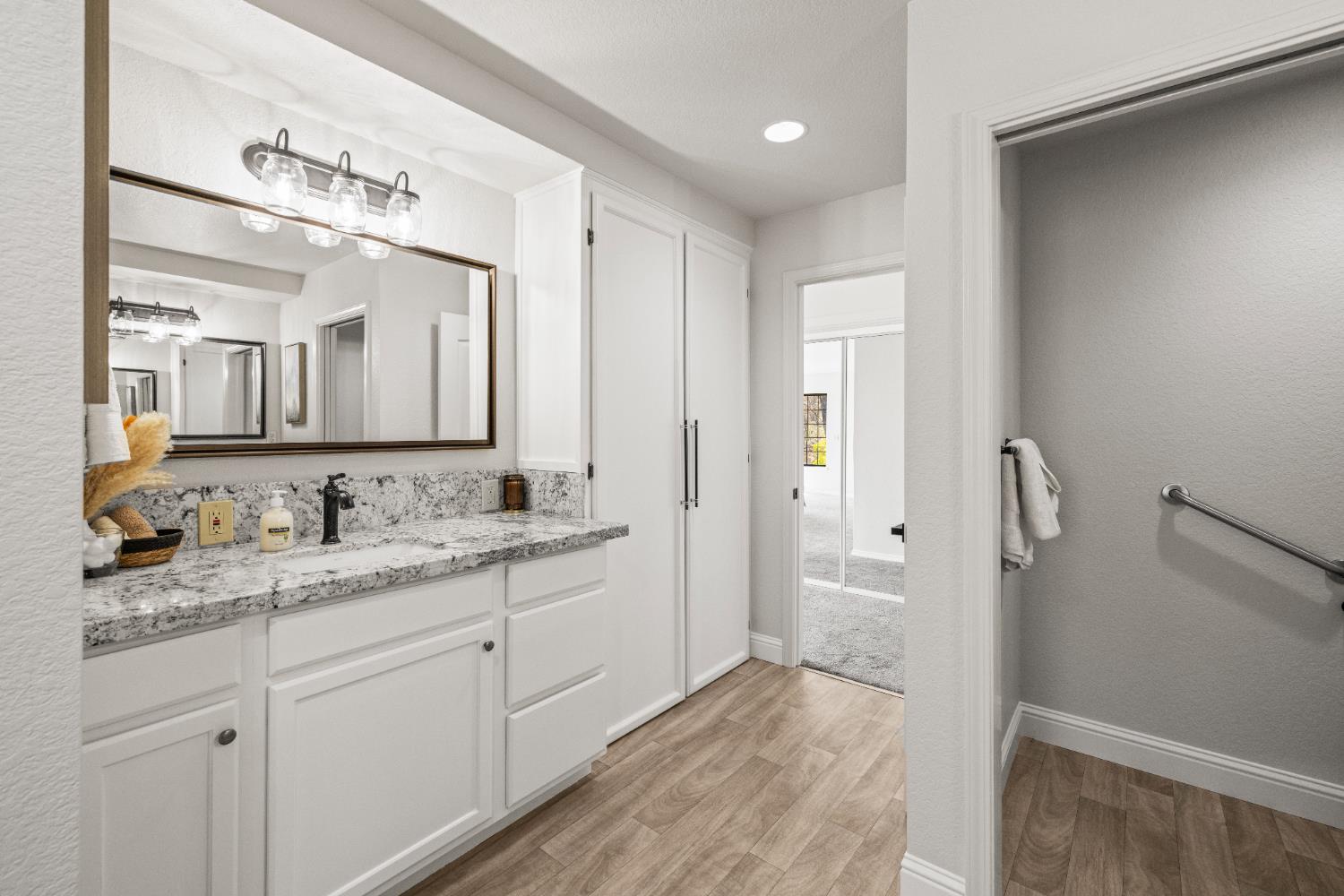 14580 McElroy Road Auburn, CA 95602 - Photo 20 of 48 a bathroom with a granite countertop sink and a mirror
