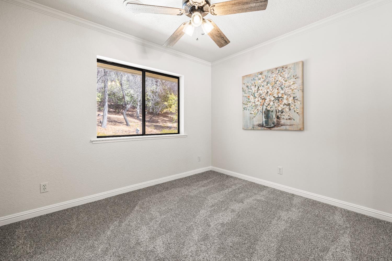 14580 McElroy Road Auburn, CA 95602 - Photo 27 of 48 an empty room with a window and a fan