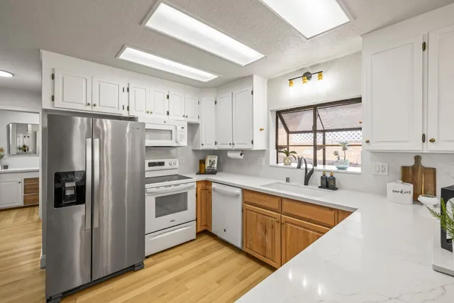 a kitchen with stainless steel appliances granite countertop a refrigerator sink and cabinets