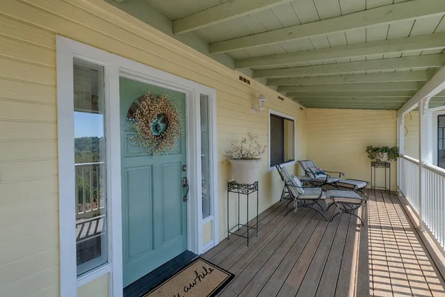 a balcony with furniture and wooden floor