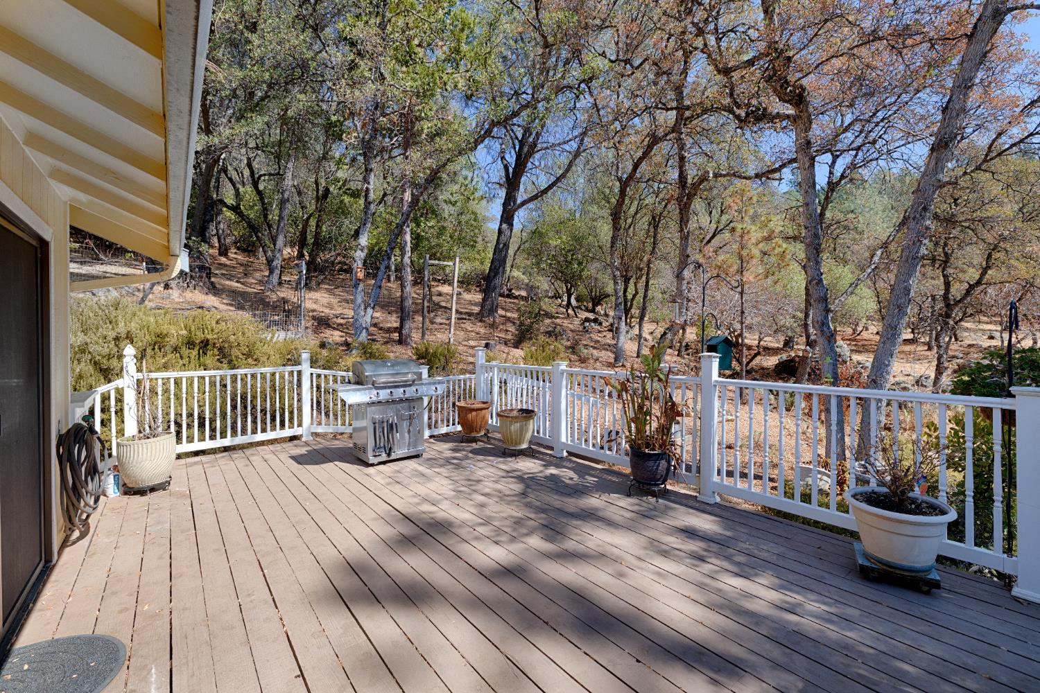 14580 McElroy Road Auburn, CA 95602 - Photo 33 of 48 a view of a deck with wooden floor and fence with a bench