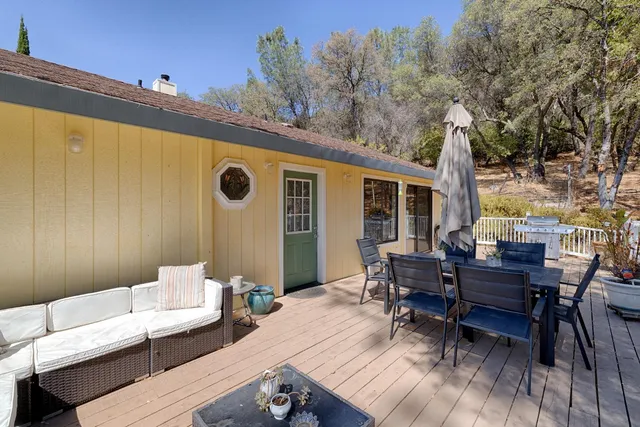 a view of a patio with table and chairs and wooden floor