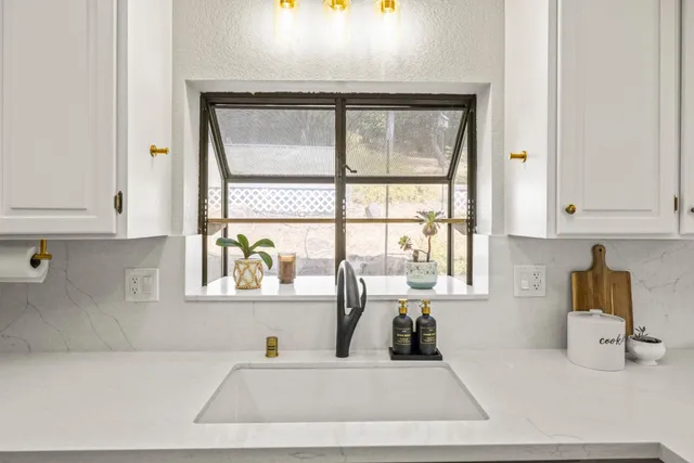 a kitchen with a window a sink and a counter top space