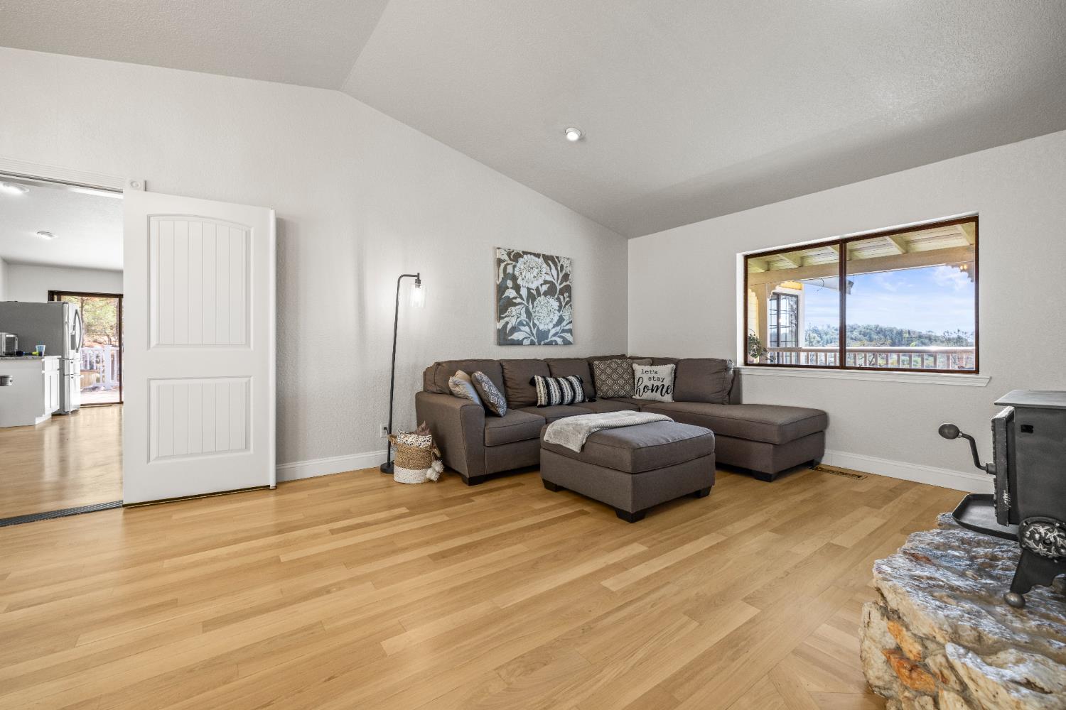 14580 McElroy Road Auburn, CA 95602 - Photo 9 of 48 a bedroom with a bed and wooden floor