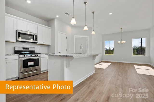 a view of kitchen with stove and microwave