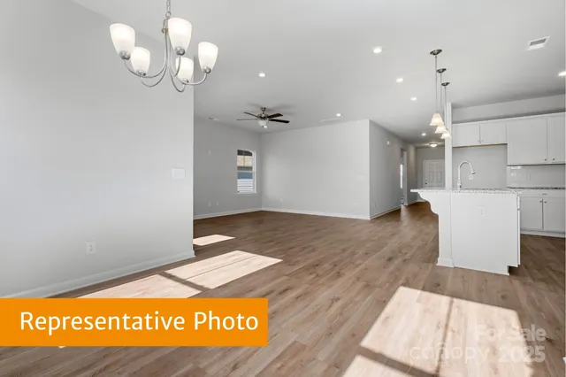 a view of a kitchen with a sink and refrigerator