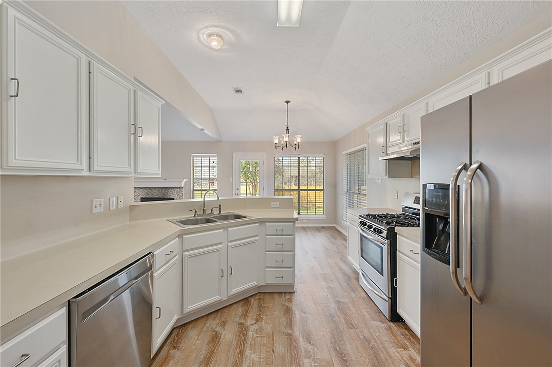 1804 Ibis Court Bryan, TX 77807 - Photo 5 of 17 a kitchen with a sink stainless steel appliances and cabinets