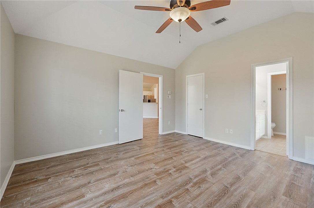 1804 Ibis Court Bryan, TX 77807 - Photo 9 of 17 a view of an empty room with wooden floor and a ceiling fan