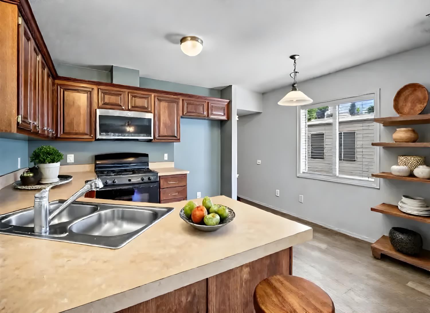 2933 Forebay Road, Unit 28 Pollock Pines, CA 95726 - Photo 17 of 26 a kitchen with stainless steel appliances a sink a stove a microwave a refrigerator a stove and cabinets