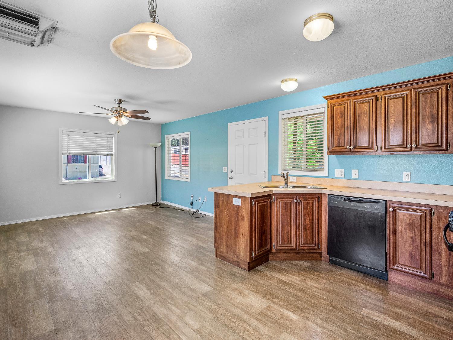 2933 Forebay Road, Unit 28 Pollock Pines, CA 95726 - Photo 19 of 26 a kitchen with stainless steel appliances granite countertop a stove a sink dishwasher and a large refrigerator with wooden floor