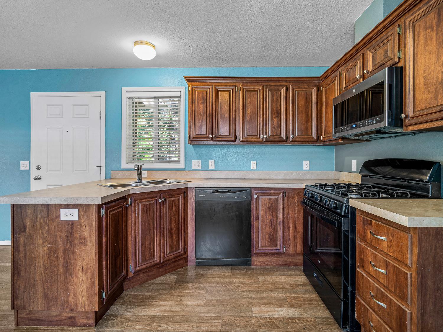 2933 Forebay Road, Unit 28 Pollock Pines, CA 95726 - Photo 20 of 26 a kitchen with stainless steel appliances granite countertop a stove a sink and a microwave
