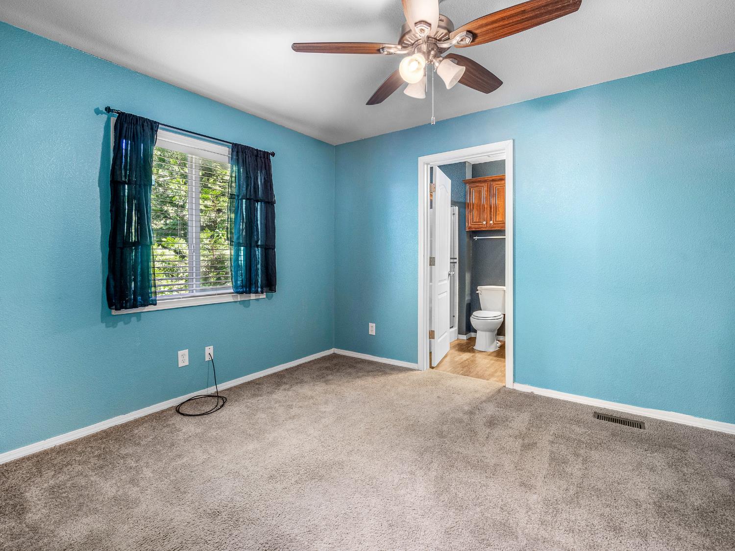 2933 Forebay Road, Unit 28 Pollock Pines, CA 95726 - Photo 5 of 26 a view of an empty room with window and chandelier fan