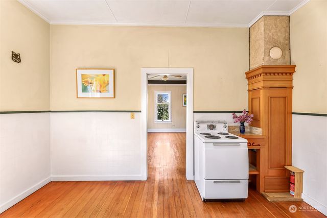 a view of a kitchen with wooden floor and electronic appliances