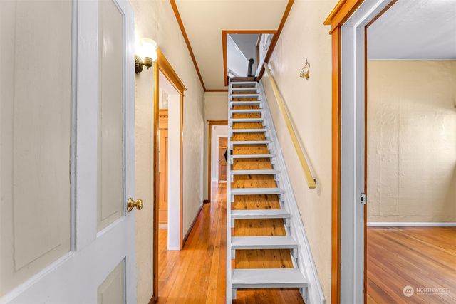 a view of staircase with wooden floor and windows