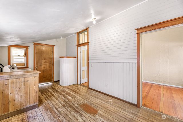 a view of a kitchen from a hallway