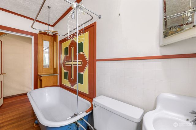 a bathroom with a toilet a sink and bathtub