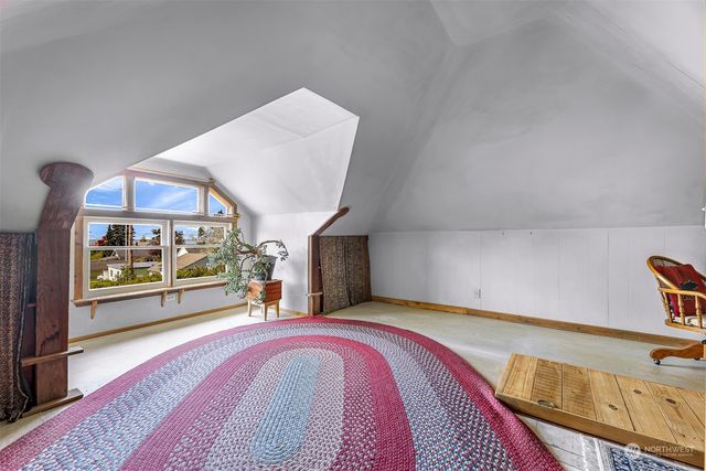 a view of a bedroom with furniture and window