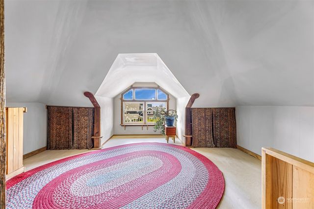 a spacious bedroom with a bed and a dresser