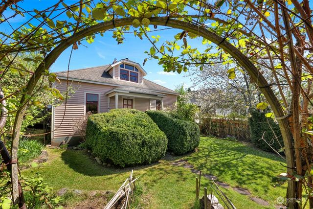 a front view of a house with a garden