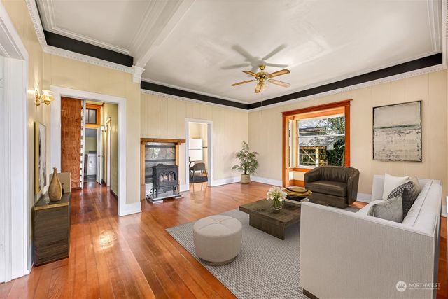 a living room with furniture and a wooden floor