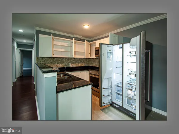 a kitchen with a refrigerator and a stove
