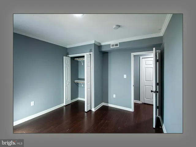a bathroom with a granite countertop sink a toilet a mirror and shower