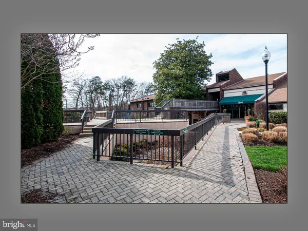a view of a brick house with wooden fence