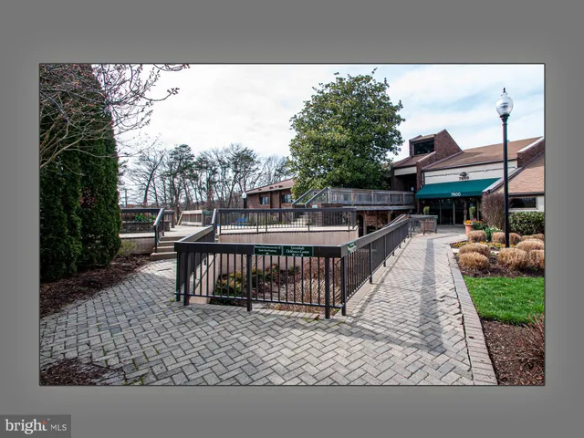 a view of a brick house with wooden fence