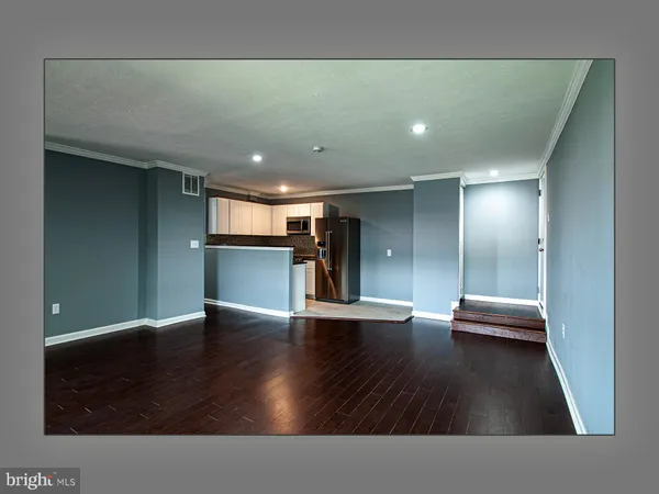 a view of hallway with stairs and wooden floor