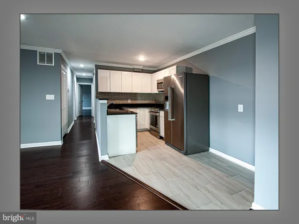 a kitchen with stainless steel appliances granite countertop a refrigerator a sink and a stove