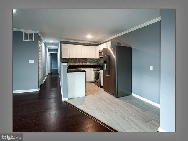 a kitchen with stainless steel appliances granite countertop a refrigerator a sink and a stove