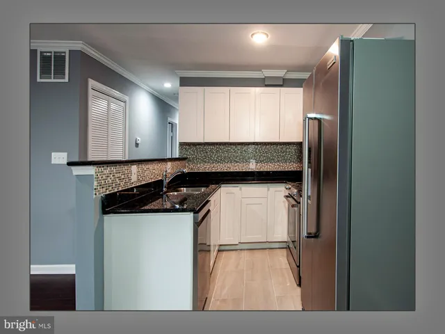 a kitchen with a refrigerator and a sink